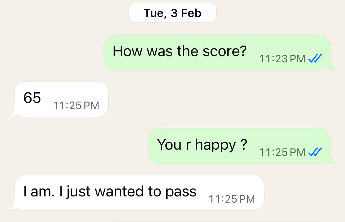 WhatsApp review showing score of 65 and student saying they were happy to pass